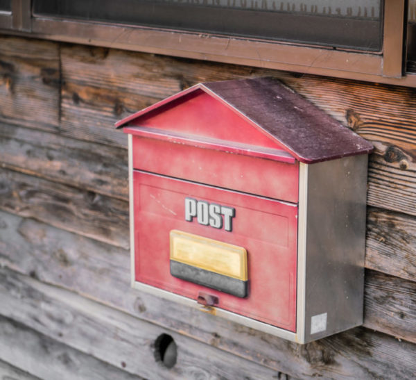 Old wooden mailbox on wood background
